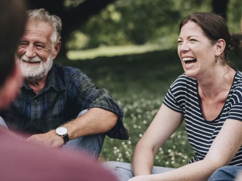 Group of people sitting in a park talking